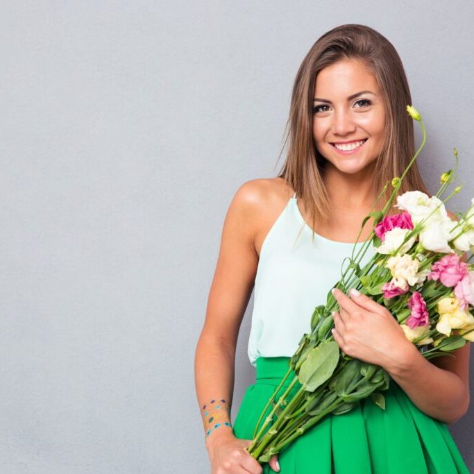 Happy woman holding flowers